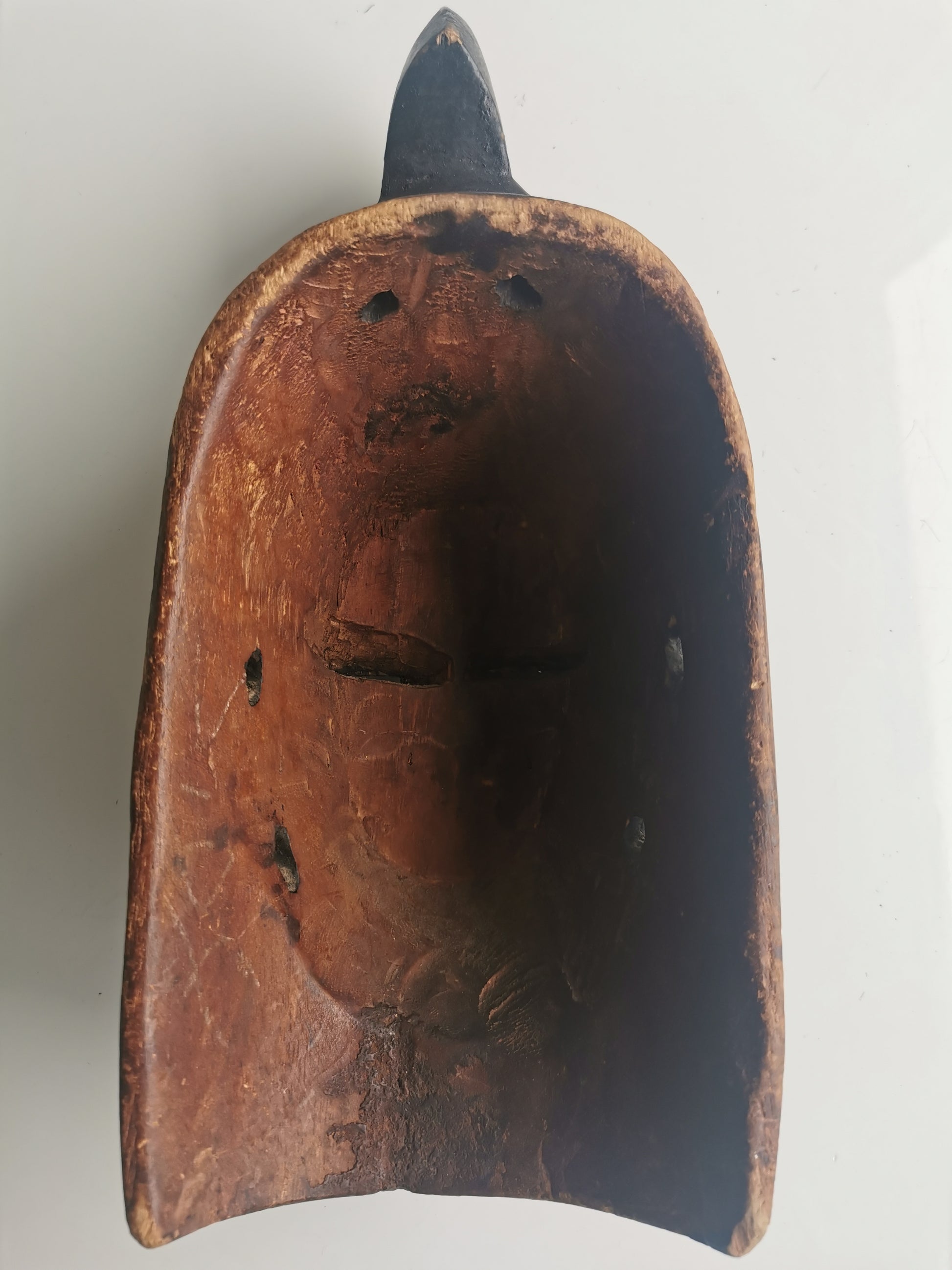 A close-up of the back of the mask's head, showing the distinctive shape of the headdress.